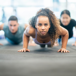 Participants practicing pushups for martial arts training to build strength and endurance.