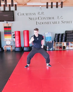 Still shot of the Colonel demonstrating the Hungar Breathing form, showcasing dynamic tension and focus in martial arts practice.