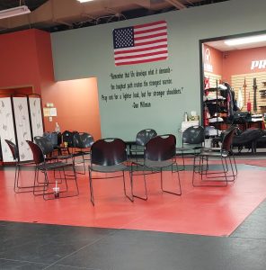 Women’s self-defense training discussion circle with chairs set up for real-life safety and awareness instruction at a martial arts school