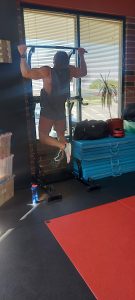 Justin Ogburn completes strict pull-ups on the pull-up tower during the Memorial Day Murph Workout