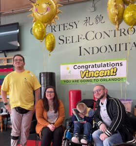 Josh Goblowsky presenting a Sunshine Foundation dream trip to Vincent and his family at a martial arts schooloh so