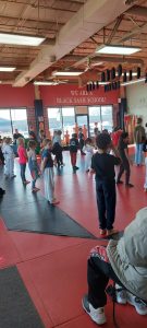 Kids on the mat during bring a friend week at AAMA.