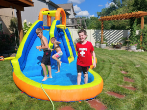 Kids play in a backyard in Bellevue NE during the summer.